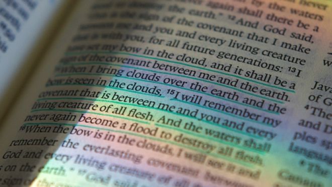 Open Bible with rainbow colours across the page