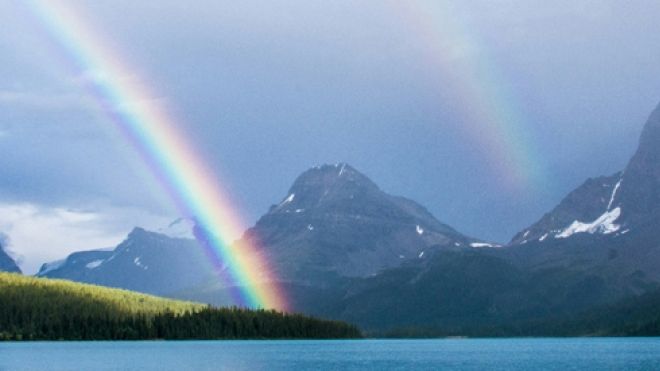 photo of rainbow from above in a mountain and sea background