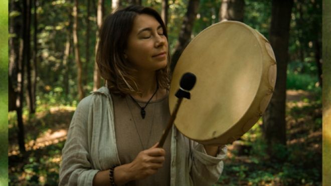 Indigenous woman drumming
