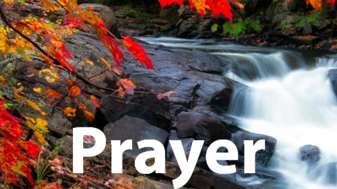 Low waterfall over rocks with fall leaves