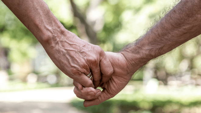 close up of two hands with a green and white background