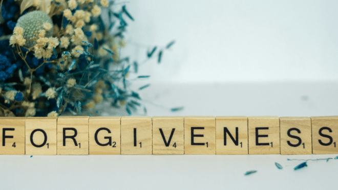 Forgiveness in Scrabble tiles with dried flowers