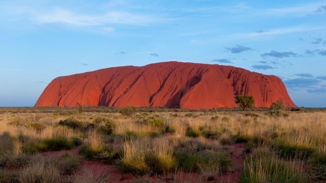Uluru in Australia, red desert landscape in a blue sky