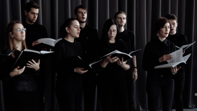 a choir in black, singing