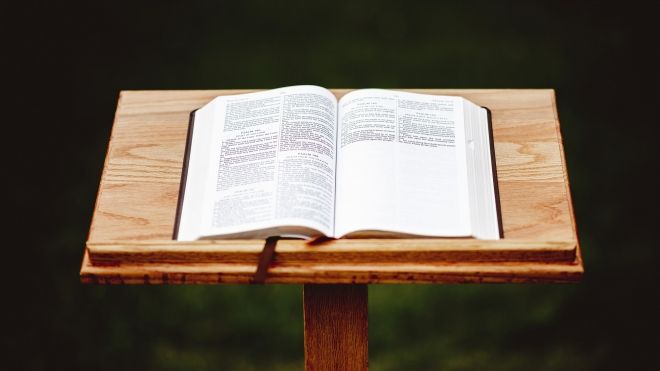 closeup-shot-wooden-speech-stand-with-opened-book