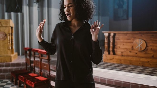 Black woman singing in a church