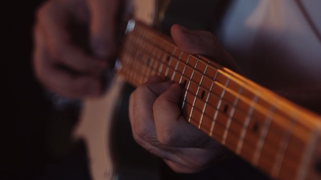 hands on a guitar