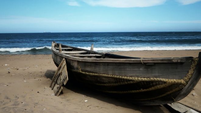 An old boat on a sandy shore