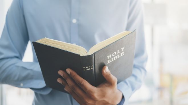man-holding-reading-holy-christian-bible