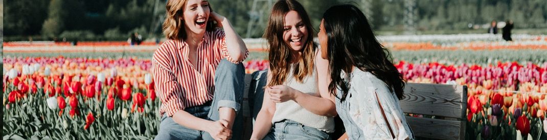 Bad Evangelists Three young women in an open field of flowers