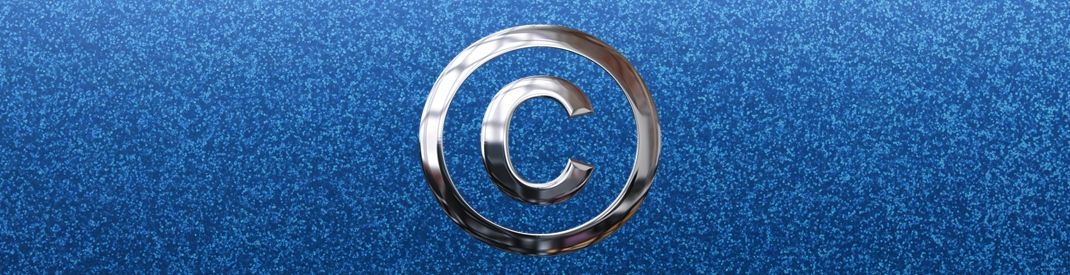 silver copyright symbol on a sparkley blue background