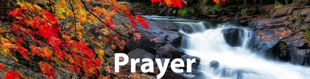 Low waterfall over rocks with fall leaves