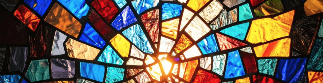 geometric shapes of coloured stained glass in a whorl pattern
