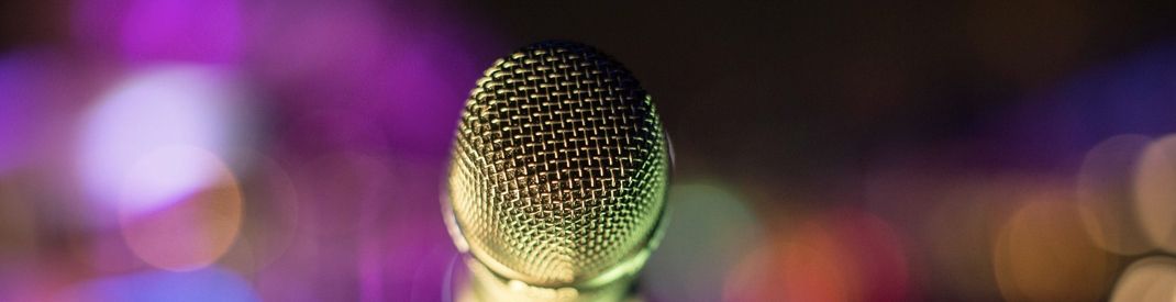 Comforting Nerves close-up of a microphone in a multicolored background