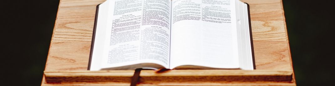 closeup-shot-wooden-speech-stand-with-opened-book
