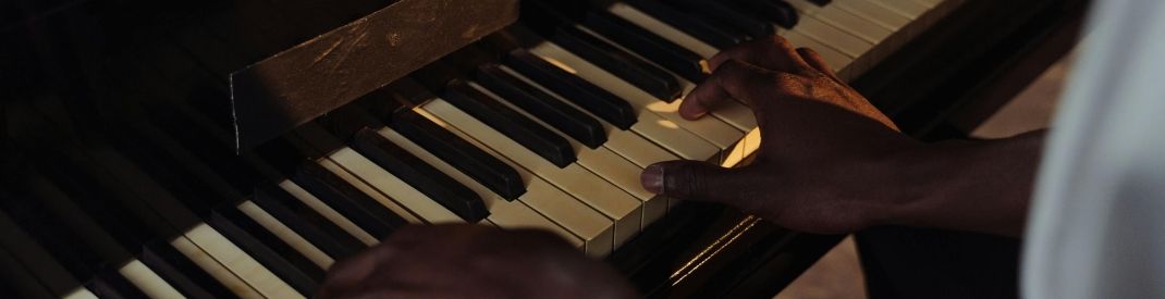 Hands on a piano two black hands on a piano