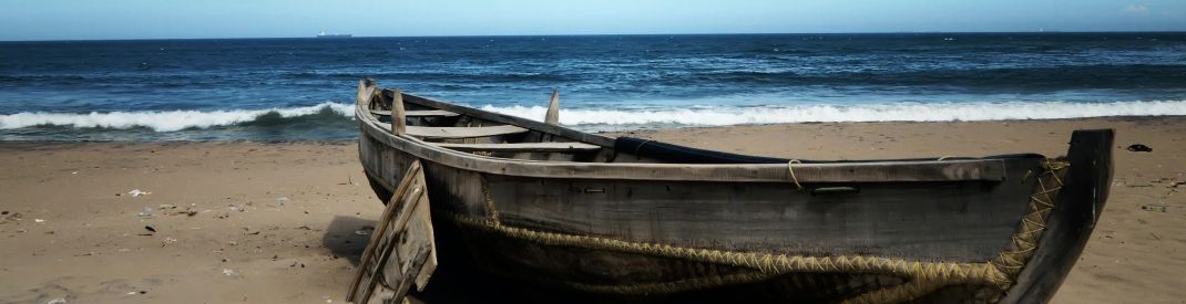 An old boat on a sandy shore An old boat on a sandy shore