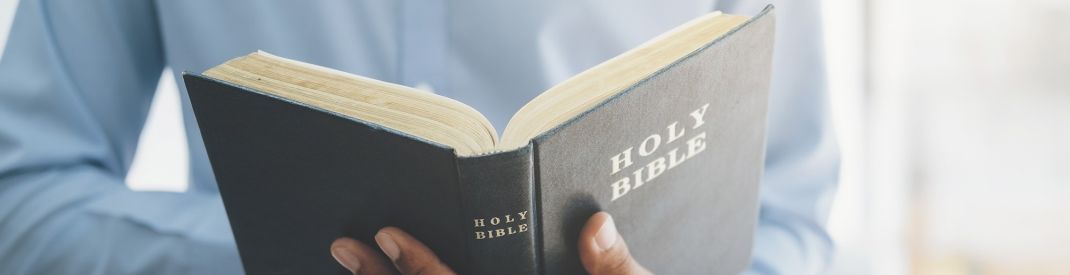 man-holding-reading-holy-christian-bible